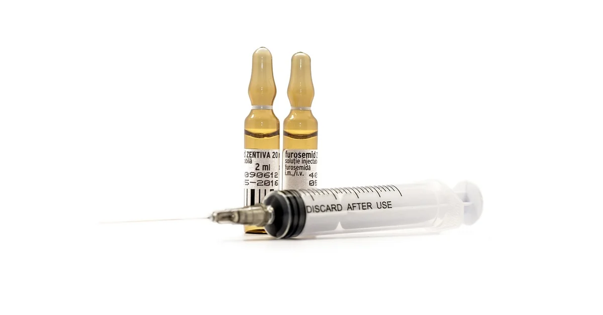 Two amber glass vials and a syringe on a white background, illustrating syringe feeding and hydration for small animals such as mice.