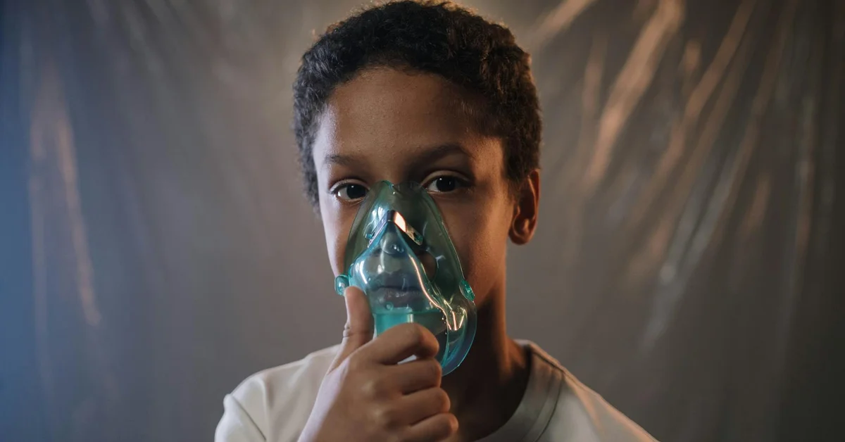 A child with a nebulizer mask for respiratory treatment.