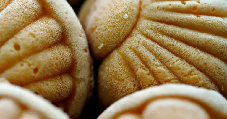 Close-up of golden-brown ridged pastries dusted with sugar