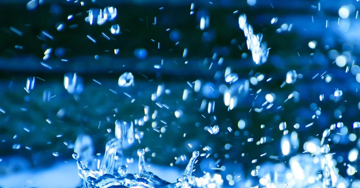 Close-up of water droplets in mid-splash, evoking the cleaning and sanitizing of props between mouse photoshoots