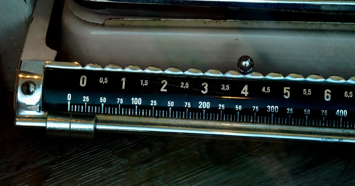 Close-up of a vintage mechanical scale with measurement markings