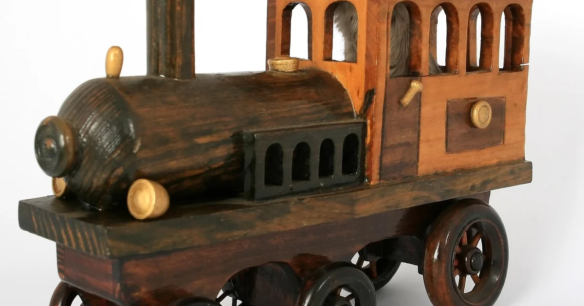 A vintage wooden toy train with a locomotive and passenger car in dark brown tones, featuring wheels and arched windows.